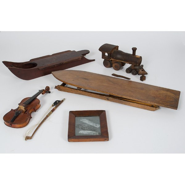 Miniature Wooden Doll Furniture : American, an assembled group of primitive doll furniture and accessories, including a doll wooden ironing board, a wooden doll sleigh, a wooden toy train, a wood framed mirror and miniature violin; la