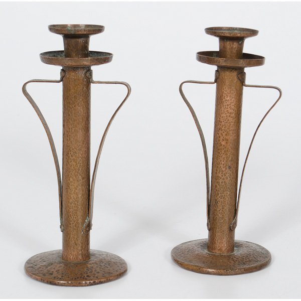 Onondaga Metal Shops Candlesticks for Stickley : America, early 20th century, a pair of Arts & Crafts hammered copper candlesticks for Stickley, marked with the Onondaga Metal Shops incised logo; ht. 9 in.