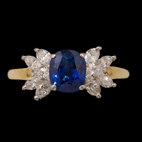Tiffany & Co. 18k Sapphire and Diamond Ring : Tiffany & Co. 18k yellow gold, platinum, blue sapphire and diamond ring containing an oval cushion-cut blue sapphire weighing approximately 1.15 ct., medium dark tone, strongly saturated, accented by 