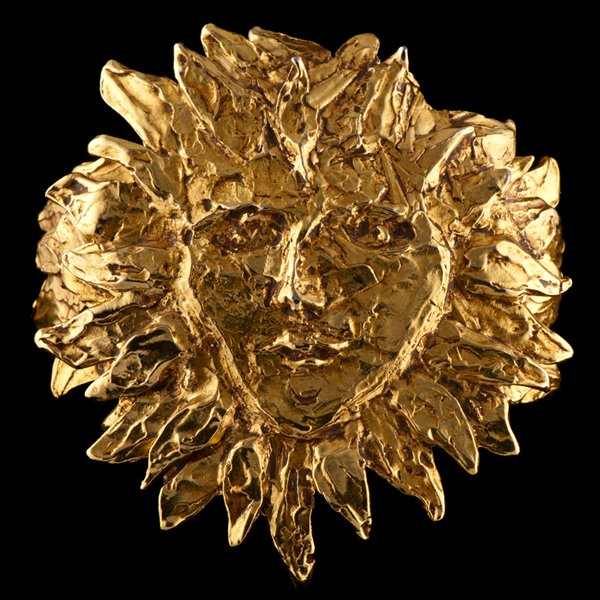 Carole Tanenbaum Personal Collection YSL Sun Worsh: Yves Saint Laurent, 1980s rare gold tone sun god cuff bracelet having the face surrounded by flames and mounted on a cuff wire, flanked by moveable flames on either side, marked YSL and Made in Franc