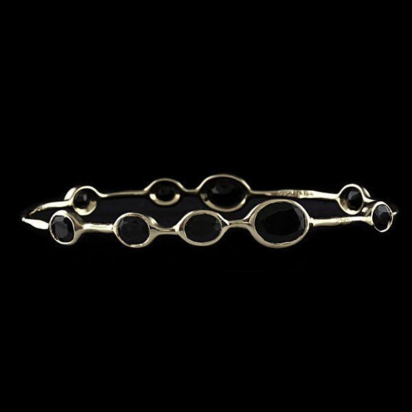 Ippolita 18k Onyx Bangle : Ippolita 18k yellow gold bangle containing eight asymmetrically spaced hand-faceted onyx. Stones range in size between 6.86 and 6.14 mm; dia. 2.75 in., wt. 9.1 dwts.