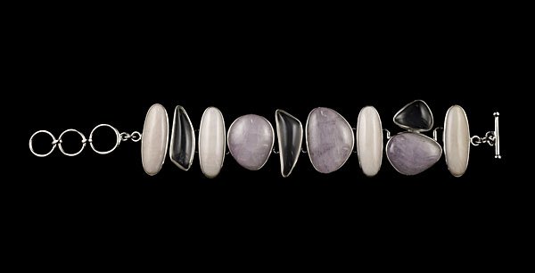 Ippolita Sterling Silver and Rose Quartz Bracelet : Ippolita sterling silver line bracelet containing 10 smooth rose quartz and rock crystal stones. Stones vary in size between 29.79 and 10.69 mm; lg. 8.25 in., wt. 77 ozt.