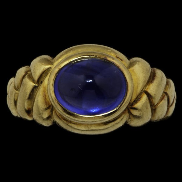 Bulgari 18k Sapphire Ring : Bulgari 18k yellow gold ring containing a blue sapphire cabochon; ring size 4.5, wt. 5.8 dwts.