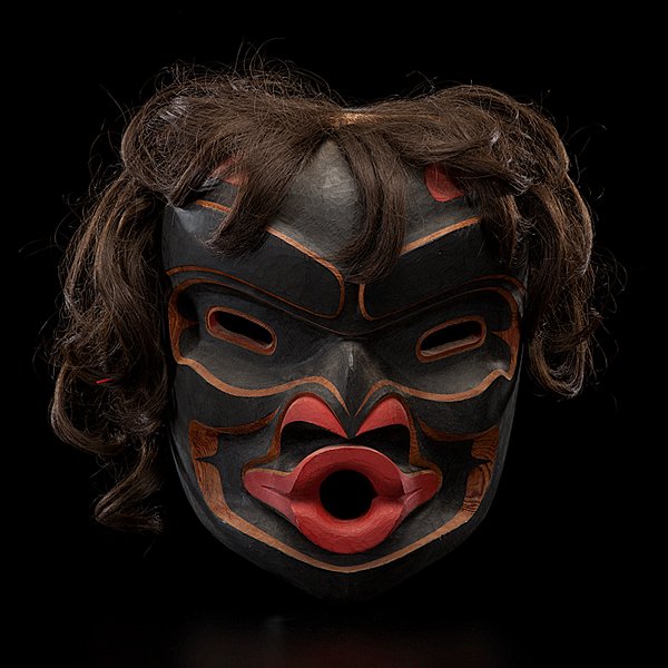 Tony Hunt Jr. Kwakwaka'wakw Carved Mask Kwagiulth W: deeply carved cedar and painted in black and red; Dzunuk’wa is depicted in a traditional way with pursed lips and black wavy hair; signed, titled, and dated on in pencil on reverse, length 9.25 