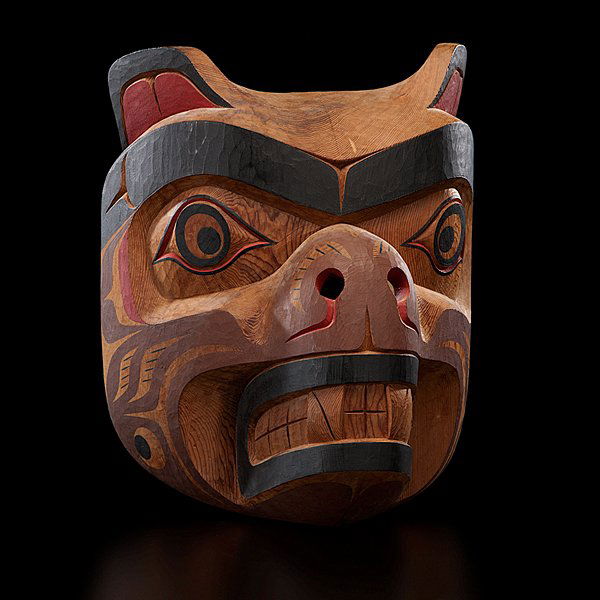Tony Hunt Jr. Kwakwaka'wakw Carved Mask Kwagiulth B: carved cedar and painted in black, brown, and red; pierced nostrils and carved fangs create a fierce being, signed and titled in ink on reverse, length 11.25 in. x width 9.25 in. fourth quarter 20th