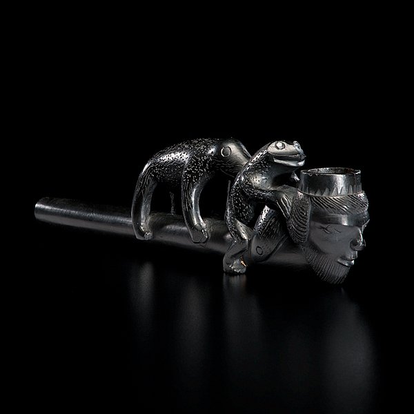 Haida Argillite Carved Figural Pipe : four-figure pipe composed of a bear, frog, fish, and man; each figure straddles the cylindrical stem, length 9 in. late 19th century