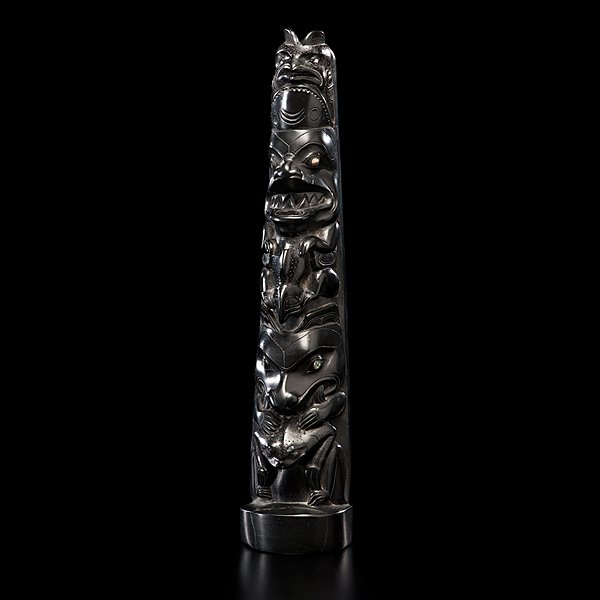 Haida Argillite Totem Pole : tapering form and carved with three figures; main figures with inset mother-of-pearl eyes; concave back, height 14 in. second quarter 20th century