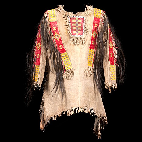 Sioux Beaded and Quilled Hide War Shirt : thread-sewn, with red, green, purple, and yellow quillwork strips decorating sleeves, shoulders, and bib; single lane of beadwork outlines the quilled bib; horsehair wrapped with quillwork hangs from