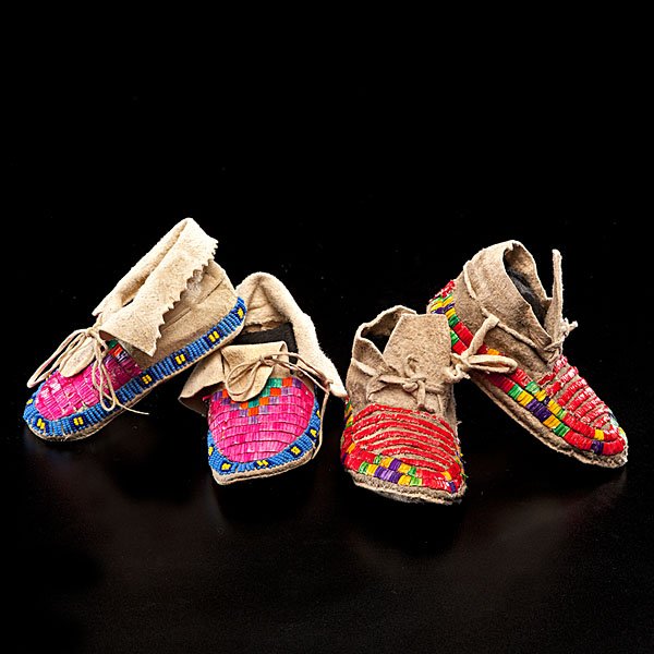 Sioux Child's Beaded and Quilled Moccasins : lot of 2, both thread and sinew-sewn; including a pair with blue and yellow beadwork around sole and pink, green, purple, and orange quillwork on vamps, length 4.5 in.; AND another decorated with band