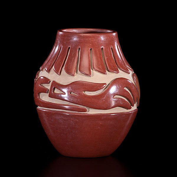 Teresita Naranjo Santa Clara Carved Redware Jar : deeply carved with Avanyu slithering around shoulder; a band of feathers hang from rim; signed on base, height 7.5 in. x diameter 6 in. mid-20th century