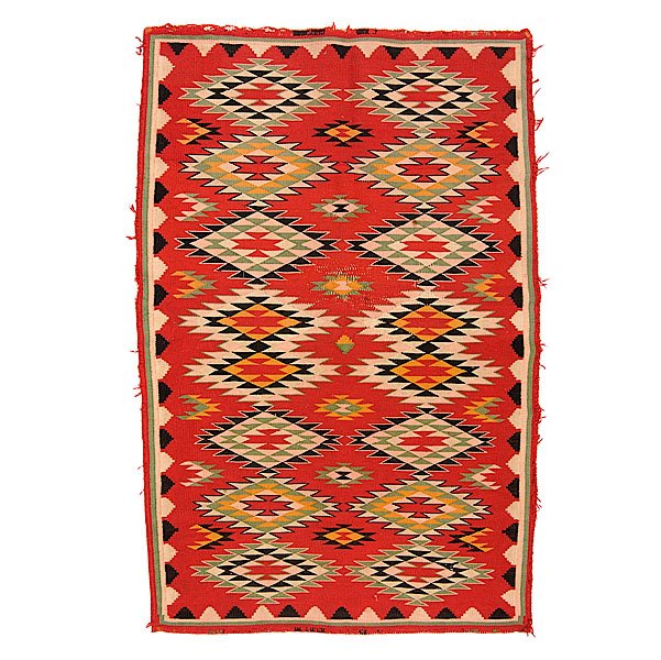 Navajo Germantown Eyedazzler Weaving : finely woven of Germantown wool using colors of red, cream, pink, green, gold, and black; outlined stacked and serrated diamonds fill central field, length 48 x 32 in. ca 1900