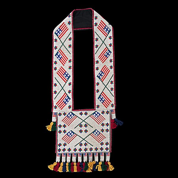 Chippewa Beaded Bandolier Bag with American Flags : thread-sewn with red, white, blue, and green beadwork filling bag with large crossed American flags; backed with felt, length 42 in. x width 16 in. contemporary