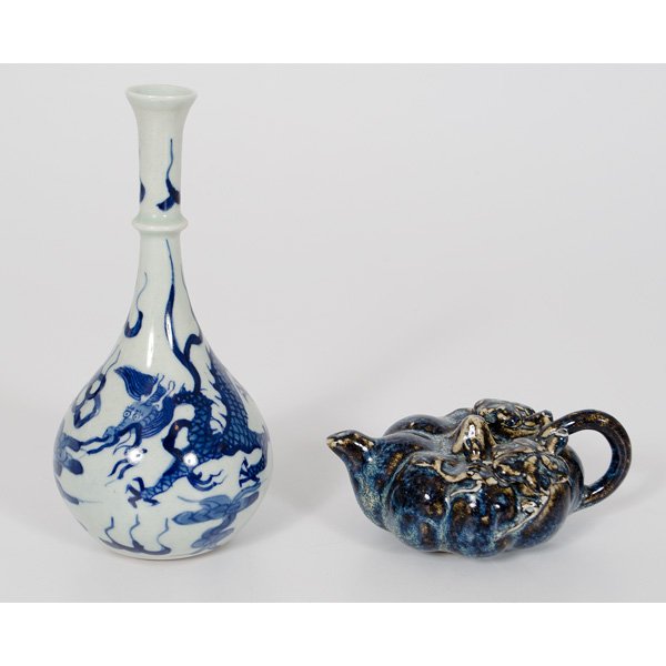Water Dropper and Bud Vase : Chinese. Two porcelain tablewares including a blue and white bud vase having dragon motifs on a white ground with a leaf on bottom, and a water dropper with applied floral motifs on a blue ground, unm