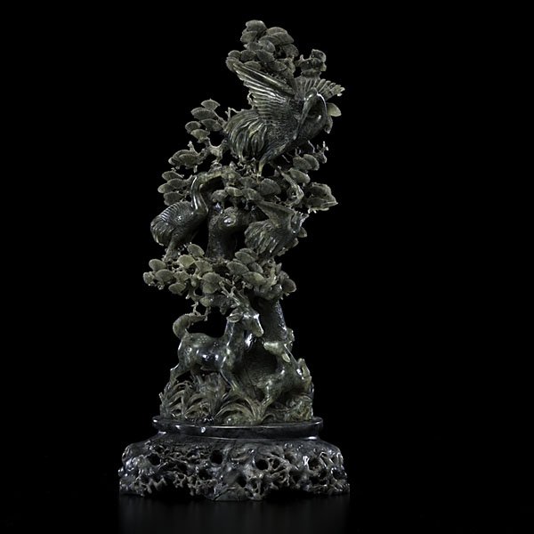 Chinese Bowanite and Soapstone Carving : Chinese. A bowanite carving depicting deer and cranes in a flowering landscape, on a soapstone stand, unmarked; ht. 22 in.