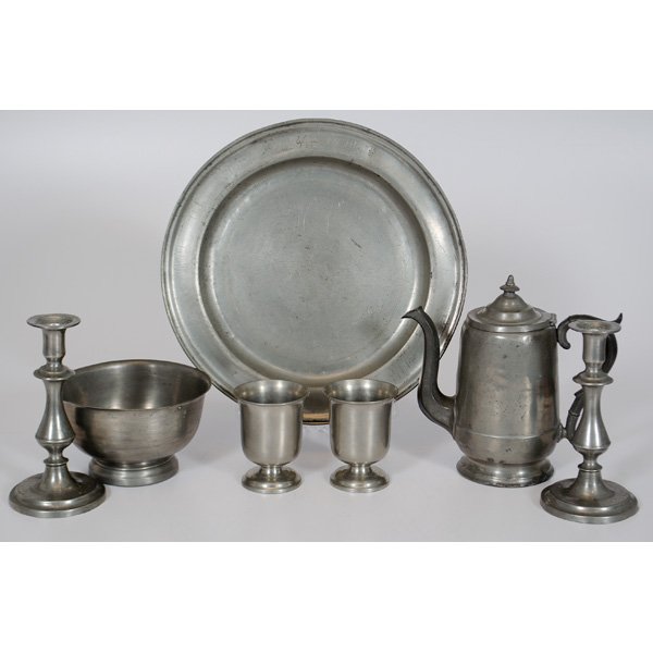 English and American Pewter : English and American, 19th century. An assembled group of seven pieces of pewter, including a circular tray, with unidentified mark, two half pint goblets, marked for England, a teapot with goose neck