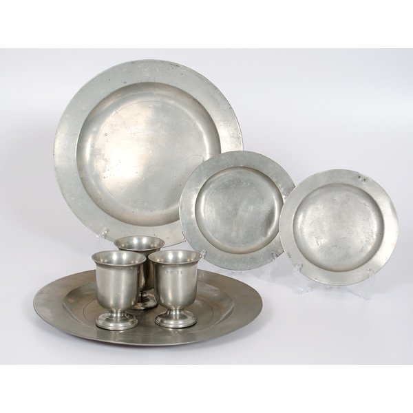 English Pewter Servers, Plates, and Beakers : British, 19th century. Assembled group of two rounded serving platters, two rounded plates, and three footed beakers, all with various British marks; tallest ht. 4.25 in., diameter 15 in.