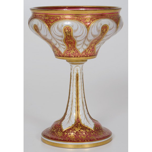 Bohemian Glass Compote : Continental. A bohemian glass compote in cranberry with white and gilt overlay; ht. 11.75 in.