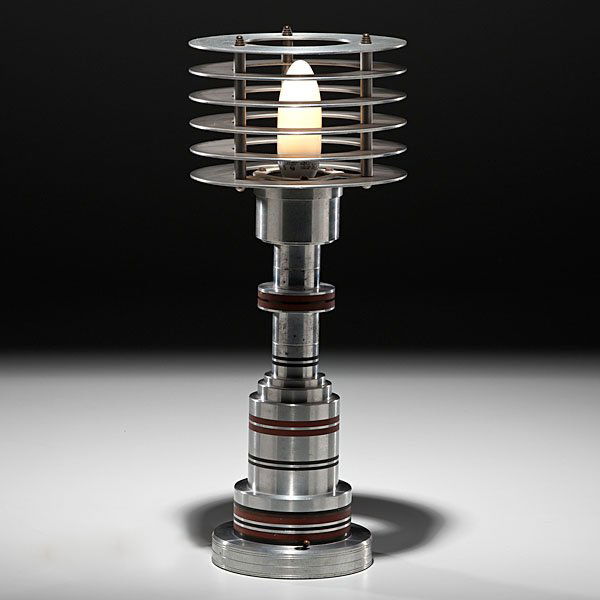 Walter Von Nessen table lamp : Walter Von Nessen table lamp America, ca 1935-1936. A tiered aluminum space age lamp with inset bands of brass and Bakelite, center socket surrounded by six horizontal spaced discs, designed by Wa
