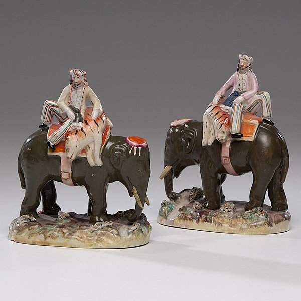 Staffordshire Elephants : Staffordshire Elephants English, 19th century. A pair of rare Staffordshire Indian elephant figures, each with a seated rider holding a tiger on its back, both unmarked; ht. 9, wd. 7 in. 