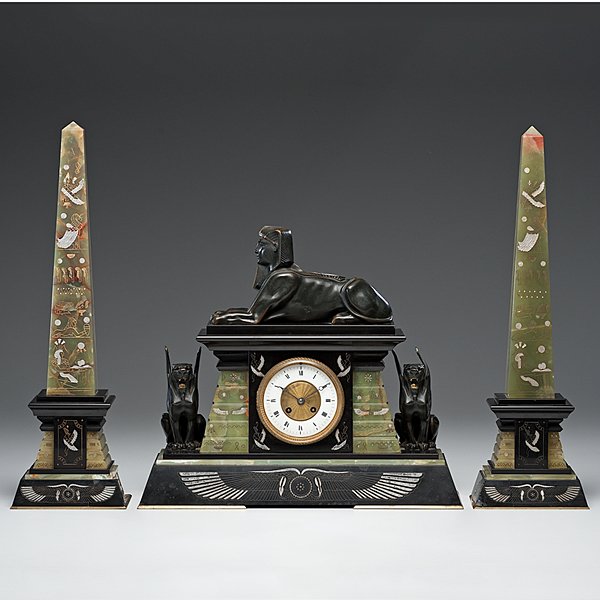 Egyptian Revival Clock Garniture : Egyptian Revival Clock Garniture French, ca 19th century. An Egyptian Revival clock with two matching obelisks, unsigned, eight day time and strike, black slate and green onyx; ht. 17 in. �