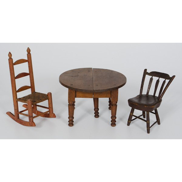 Miniature Wooden Doll Furniture : Miniature Wooden Doll Furniture American. An assembled group of early wooden doll furniture including a round dining table, a slat back rocker with cane seat, and an arrow back wood chair; t