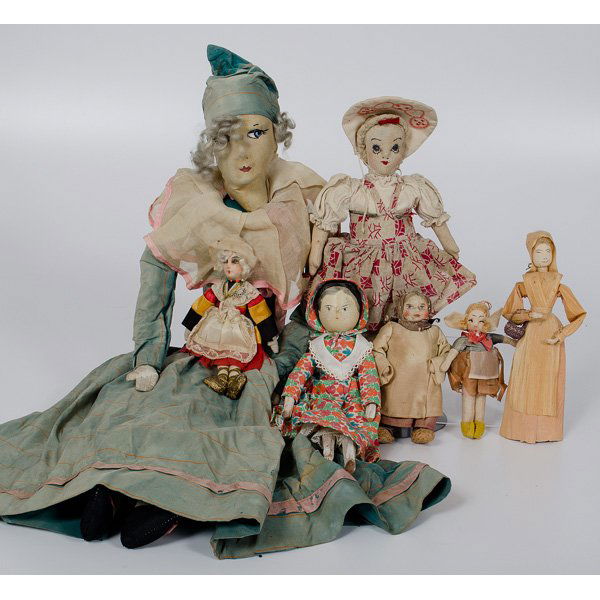 Group of Cloth, Wood and Husk Dolls : Group of Cloth, Wood and Husk Dolls Collection of seven dolls, including one corn husk doll with small basket, a primitive carved wooden doll with jointed limbs, four small cloth faced dolls, and on