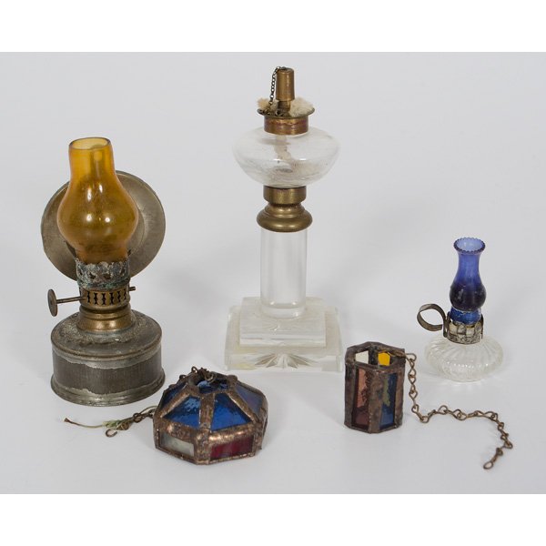 Miniature Oil Lamps and Lighting : Miniature Oil Lamps and Lighting A group of miniature oil lamps, including a tin oil lamp with amber chimney, a two pressed glass miniature oil lamps; largest ht. 5 in.; Plus two stained gla