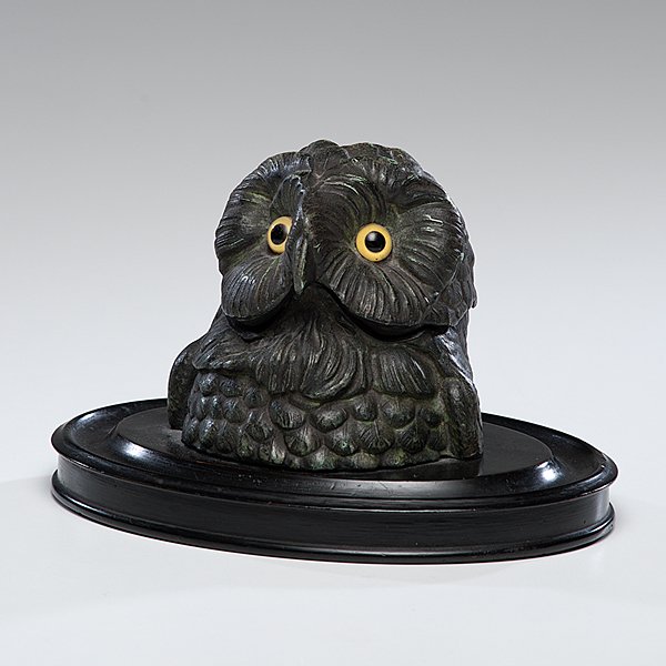 Owl Figural Inkwell : Owl Figural Inkwell 19th century. A metal owl figural inkwell with glass eyes, the hinged lid opens to reveal a porcelain inkwell, on a newer wooden base, unmarked; ht. 5.5 in.