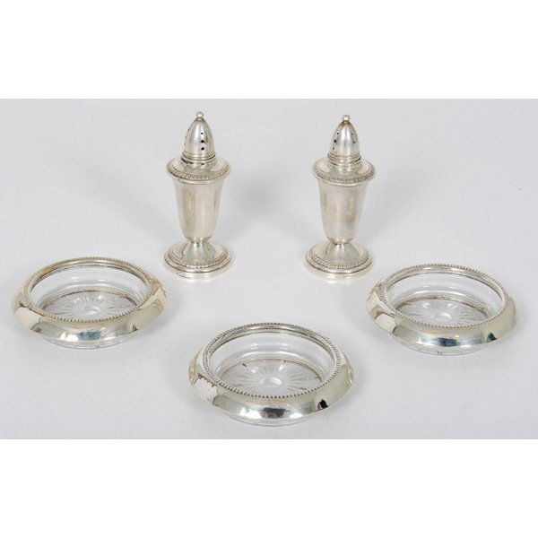 Sterling Pepper Shakers and Coasters : Sterling Pepper Shakers and Coasters American, 20th century. A pair of weighted sterling pepper shakers and three glass and sterling coasters, the shakers marked for Crown Silver Inc. with Crown ove