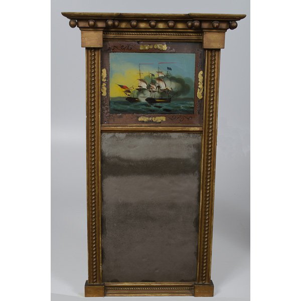 Federal Eglomise Mirror : Federal Eglomise Mirror American, early 19th century. A Federal giltwood and eglomise mirror, with tablet depicting a ship battle, the blocked cornice hung with spherules; ht. 34.25, wd. 20 in. �