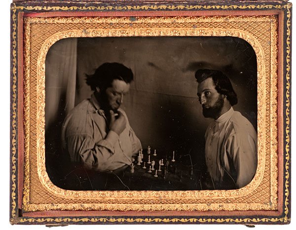 Quarter Plate Ambrotype of Chess Players : Quarter Plate Ambrotype of Chess Players Wonderful, candid quarter plate ambrotype of two men concentrating on a chess game on the table between them, with traditional turned ivory pieces. The gentl