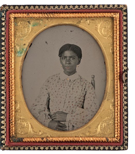 Sixth Plate Ambrotype of a Well-Dressed African Ame: Sixth Plate Ambrotype of a Well-Dressed African American Woman Sixth plate ambrotype of a young African American woman, possibly a house servant, wearing a white, lace-collared dress adorned with sm