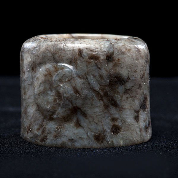 Chinese Gray Jade Archer's Ring : Chinese Gray Jade Archer's Ring 18 century or earlier. Jade of gray color with darker markings. Surface carved with peaches; ht. 1 in. Ex Collection of Dr. Herman Charles and Jannette Groman of
