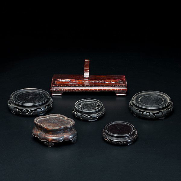Collection of Asian Stands : Collection of Asian Stands Chinese, a group of six (6) stands, one horizontal, early 20th century, and the others circular, all of carved wood; longest 8.5 in.
