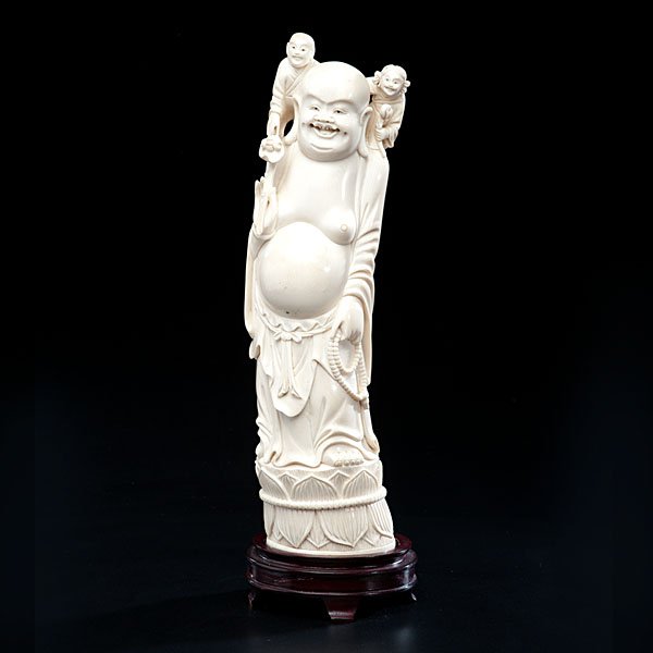 Chinese Carved Ivory Buddha : Chinese Carved Ivory Buddha Early 20th century. A carved ivory scene study of Mi Lo Fu playing with two children, well polished and on hardwood stand; ht. of ivory 12 in.