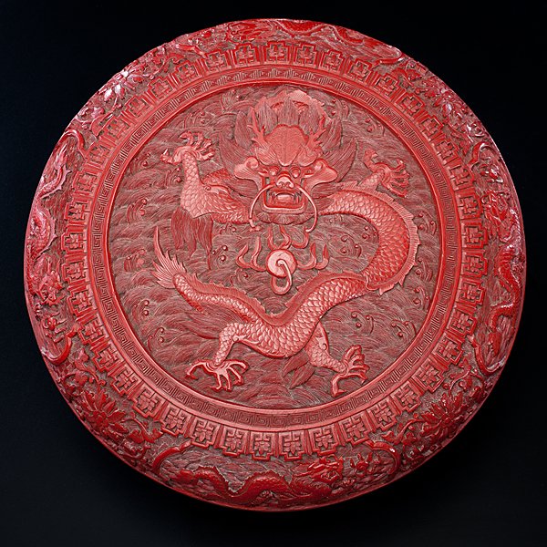 Chinese Carved Cinnabar Box : Chinese Carved Cinnabar Box Chinese, 19th century. A carved cinnabar lacquer nine dragon round covered box, the top carved with a large full-faced five-claw dragon with a flaming pearl on a groun