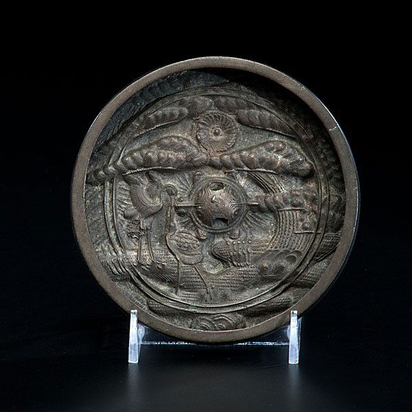Japanese Bronze Mirror : Japanese Bronze Mirror 18th/19th century. A small bronze mirror with very fine relief casting including clouds, tortoise, cranes and pine trees, the reverse mirror unpolished; diameter 4.5 in. Ex