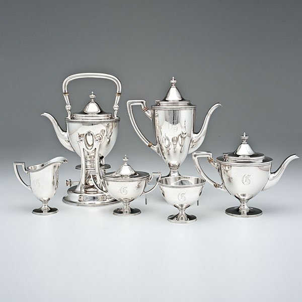 Tiffany & Co. Sterling Coffee and Tea Service : American, early 20th century. A Tiffany & Co. sterling silver six-piece tea and coffee service, including a tea pot, coffee pot, hot water kettle on stand, creamer, lidded sugar and waste, each of vas