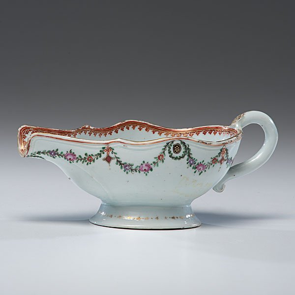 Chinese Export Famille Rose Armorial Sauceboat : Chinese export, ca 1780. A famille rose armorial porcelain sauceboat, having a polychrome garland decoration to exterior, spear borders on rim and armorial on interior, unmarked; ht. 4, lg. 9.25 in. �