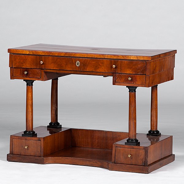 Biedermeier Writing Desk in Walnut Veneers : Continental, ca 1835. A Neoclassical writing desk in walnut veneers, of rectangular form, having a pull-out writing drawer fitted with four interior drawers and with a drop-down front panel, with two 