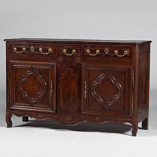 French Provincial Sideboard : French, 19th century. A provincial walnut sideboard with inlaid pinwheel decoration, three dovetailed drawers over two paneled doors with shelved interior, scrolled skirt and feet; ht. 41. wd. 64, dp