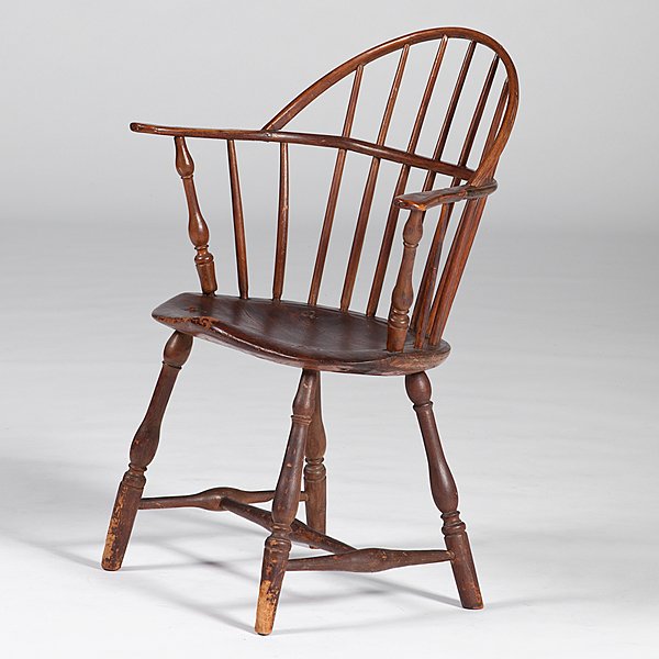 American Windsor Sack-Back Armchair : American Windsor Sack-Back Armchair American, 19th century. A Windsor sack-back armchair of mixed hardwoods, having seven spindles, a saddle seat, turned legs and H-stretchers; oah. 35, seat ht. 17 