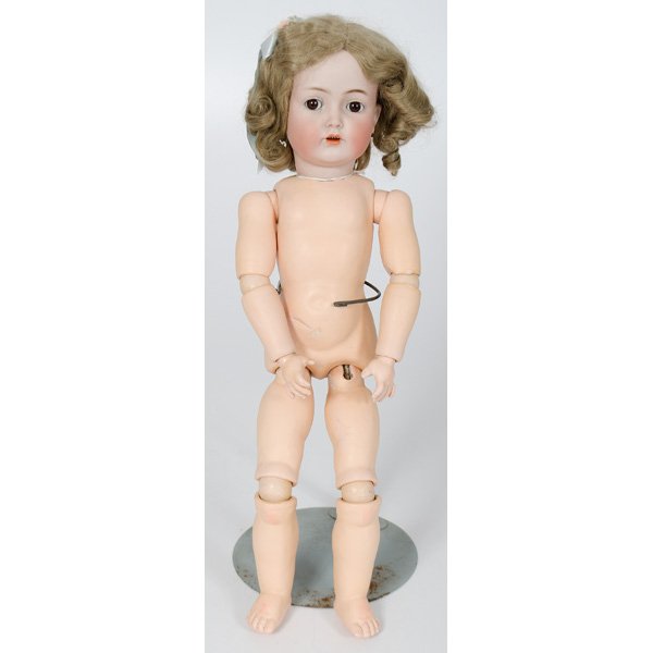 Simon and Halbig Jointed Doll : Simon and Halbig Jointed Doll German, 20th century. A bisque head doll having sleepy eyes, an open mouth showing four teeth, and wearing a blonde curled wig, and a jointed, composite body, incised S