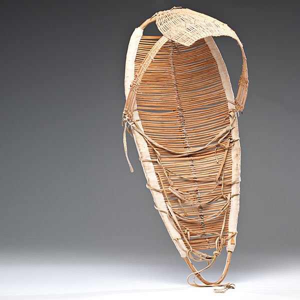Pitt River Child's Cradle : Pitt River Child's Cradle wooden slat backboard edged with canvas and bound through center with cotton; basketry visor attached to backboard with hide thongs, length 13.5 in. x width 12 in. early 2