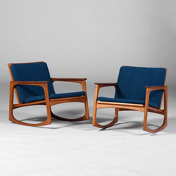 Jacob Kjaer Rocking Chairs : Danish. A pair of Jacob Kjaer-designed teak rocking chairs with navy blue cushions, marked with burnt JK Made in Denmark logo and round metal Danish Furniture Makers Control label; ht. 26, wd. 25.75