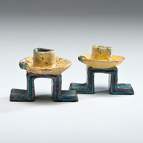 Wiener Werkstätte Ceramic Candlesticks by Gudrun Baudis: Austria, ca 1930-1940. A pair of ceramic candlesticks with geometric blue glaze bases and yellow cups, from Wiener Werkstätte, by Gudrun Baudisch. Underside of base marked with WW logo, artist's mark