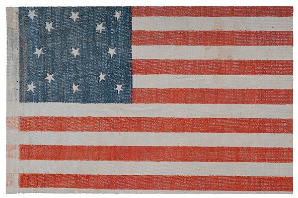 13-Star National Parade Flag : 13-Star National Parade Flag Starched gauze, 6.25 x 4 in., printed national parade flag with 13 stars arranged in a wreath pattern. 1875-1876. Made for the U.S. Centennial celebrations held in 1