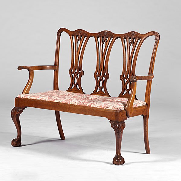 Chippendale-Style Triple Chair-Back Settee : American, 19th century. A Chippendale-style triple chair-back settee in mahogany with carved strapwork splats, finely carved scrolled arms, upholstered slip seat and cabriole legs with carved knees, o