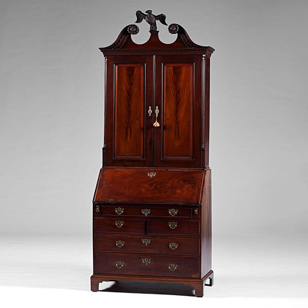 Philadelphia Chippendale Secretary Bookcase : American (Philadelphia, PA), 18th century. A Chippendale mahogany secretary bookcase, the Philadelphia top with a broken-scroll pediment with carved rosettes and a central carved eagle, over fluted co