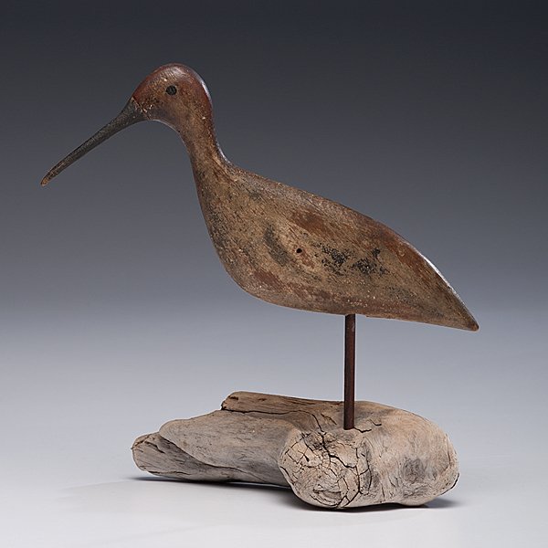 Shorebird by Lou Barkelow : Forked River, New Jersey, ca 1880-1890. A carved and hand-painted shorebird decoy by Lou Barkelow, having painted eyes, stamped S.G.H. and B.P. on bottom, on a driftwood stand; lg. 10.5 in.